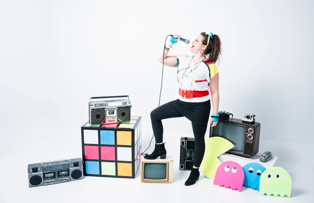 missy delorean holding a microphone around 80s props