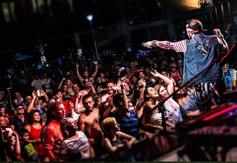 cary from the deloreans pointing a microphone at the audience