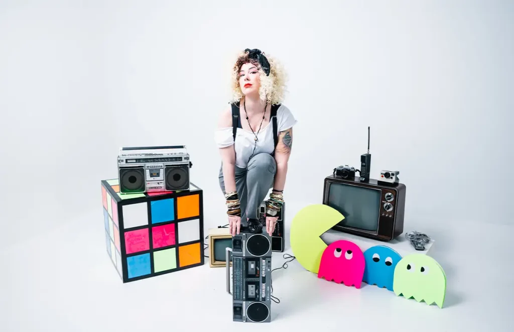 joannarama posing with foot on boombox surrounded by 80s props