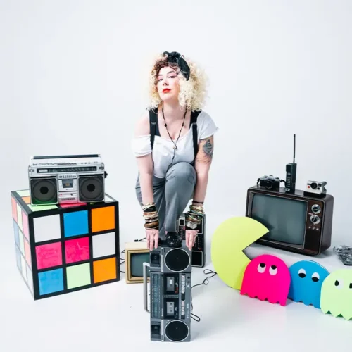 joannarama posing with foot on boombox surrounded by 80s props